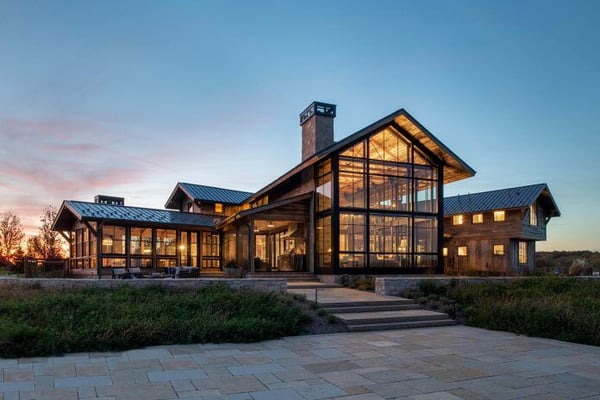 Luxury barndominium with unique design, metal roof, and big windows to let in natural light.
