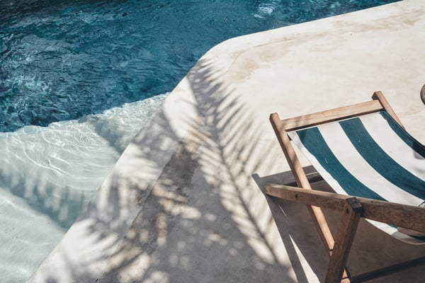 A pool chair next to a pool