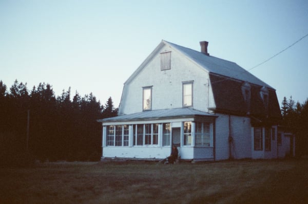 An old white farmhouse in the country
