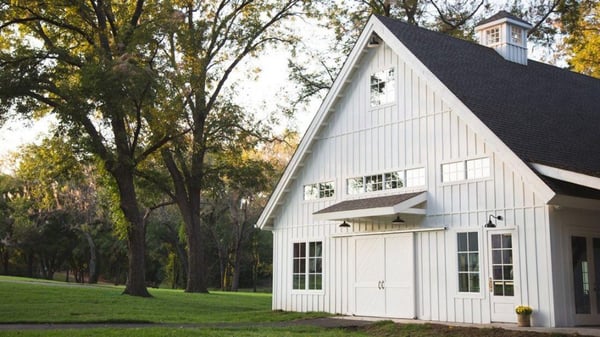 White barn farm house built in a traditional style meant to emulate the original barn house features and architectural design.