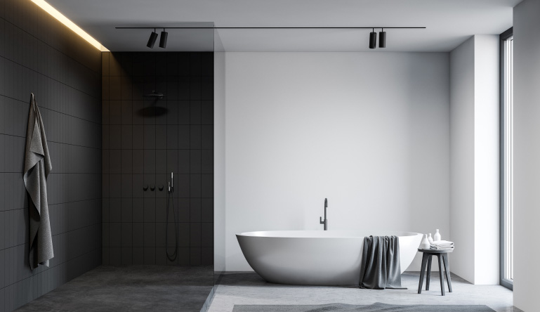 A modern bathroom design with black shower tiles and white walls