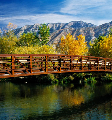 A bridge amongst beautiful mountains and fall leaves in Utah County