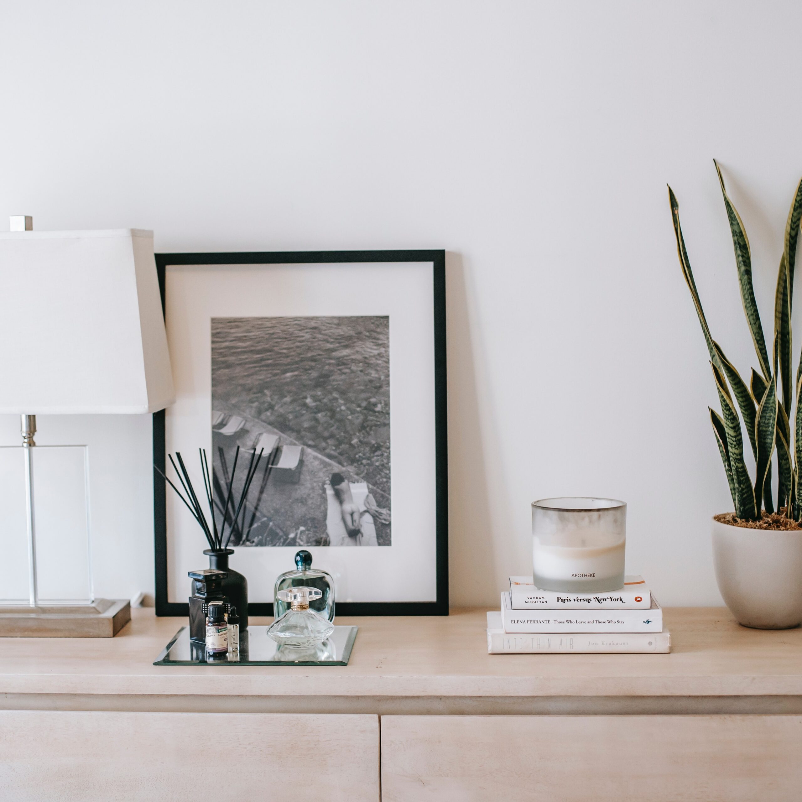 A Southwestern or Spanish style house interior design including a dresser with desert style plants.